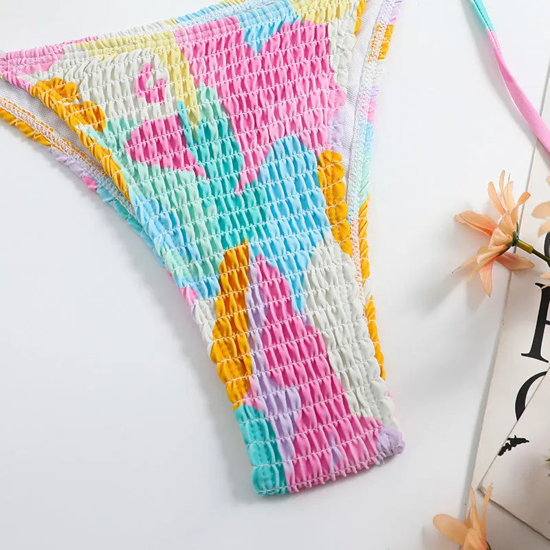 Women's triangle bikini swimming suit with floral gradient pattern and smocking craft detailing