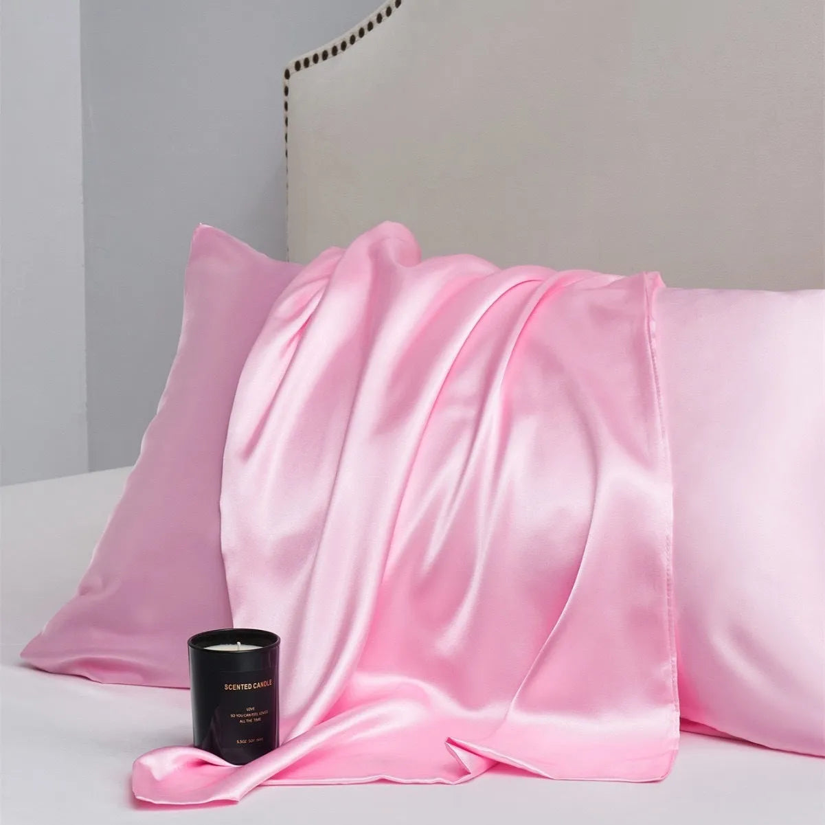 A pair of solid colour satin pillowcases made from polyester fibre, shown in one of 13 available colours.