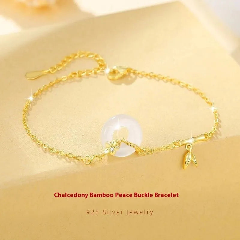 Silver women's bracelet with peace buckle charm, white chalcedony stone, and starry sky design with gold electroplating.