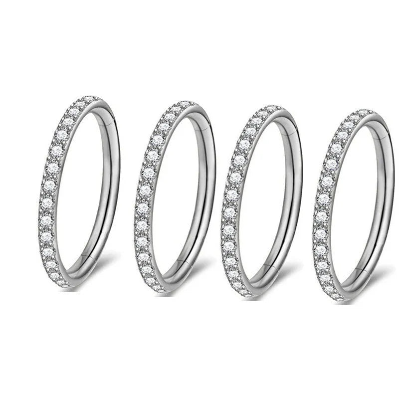 Seamless stainless steel nose ring with a central diamond decoration, shown in gold and rose gold finishes.