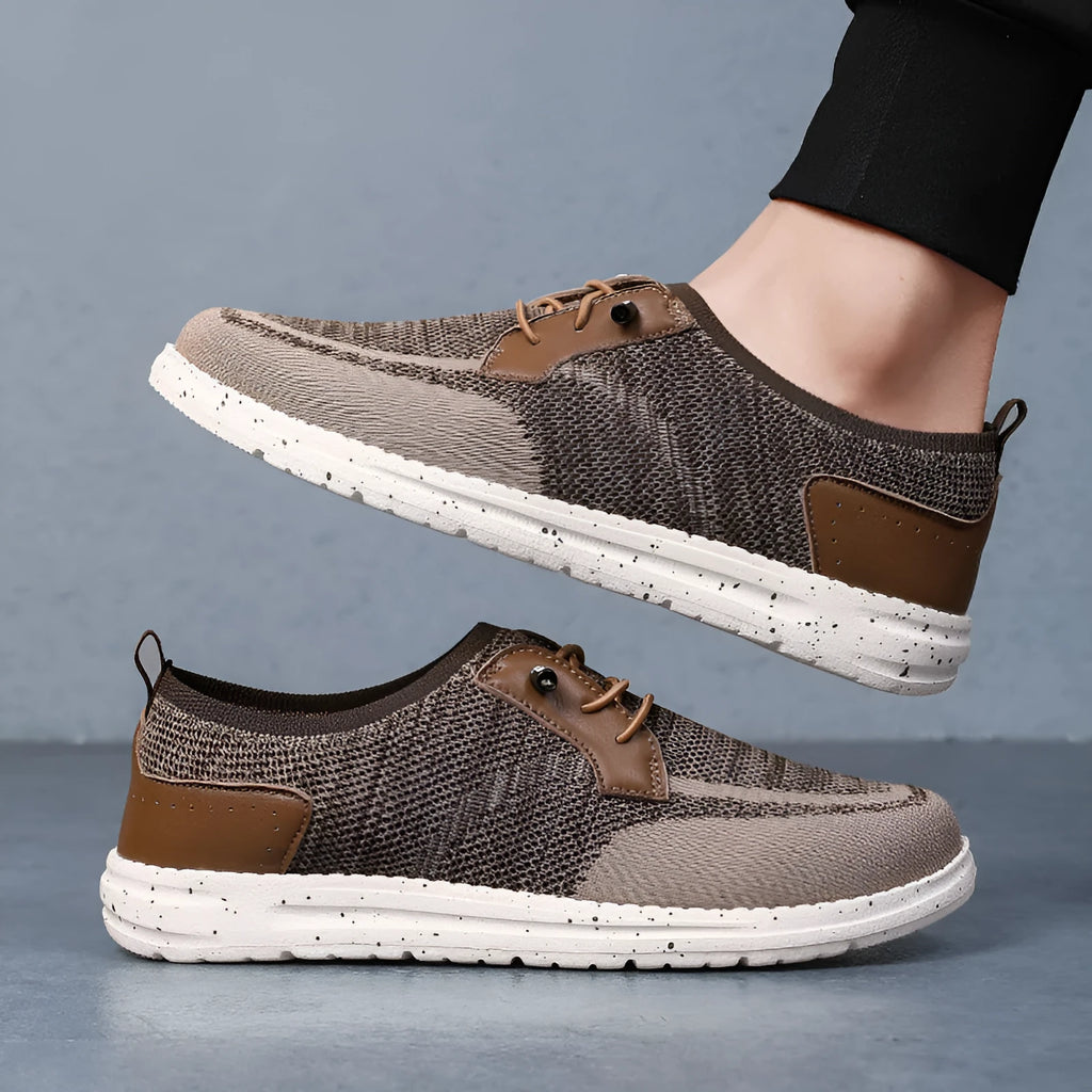 Men's black laceless canvas slip-on casual shoes with a round toe and rubber sole.