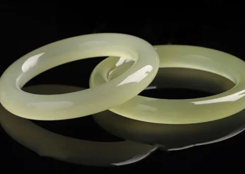 Ice-like silk jade round bar bracelet showing smooth stone surface and circular form