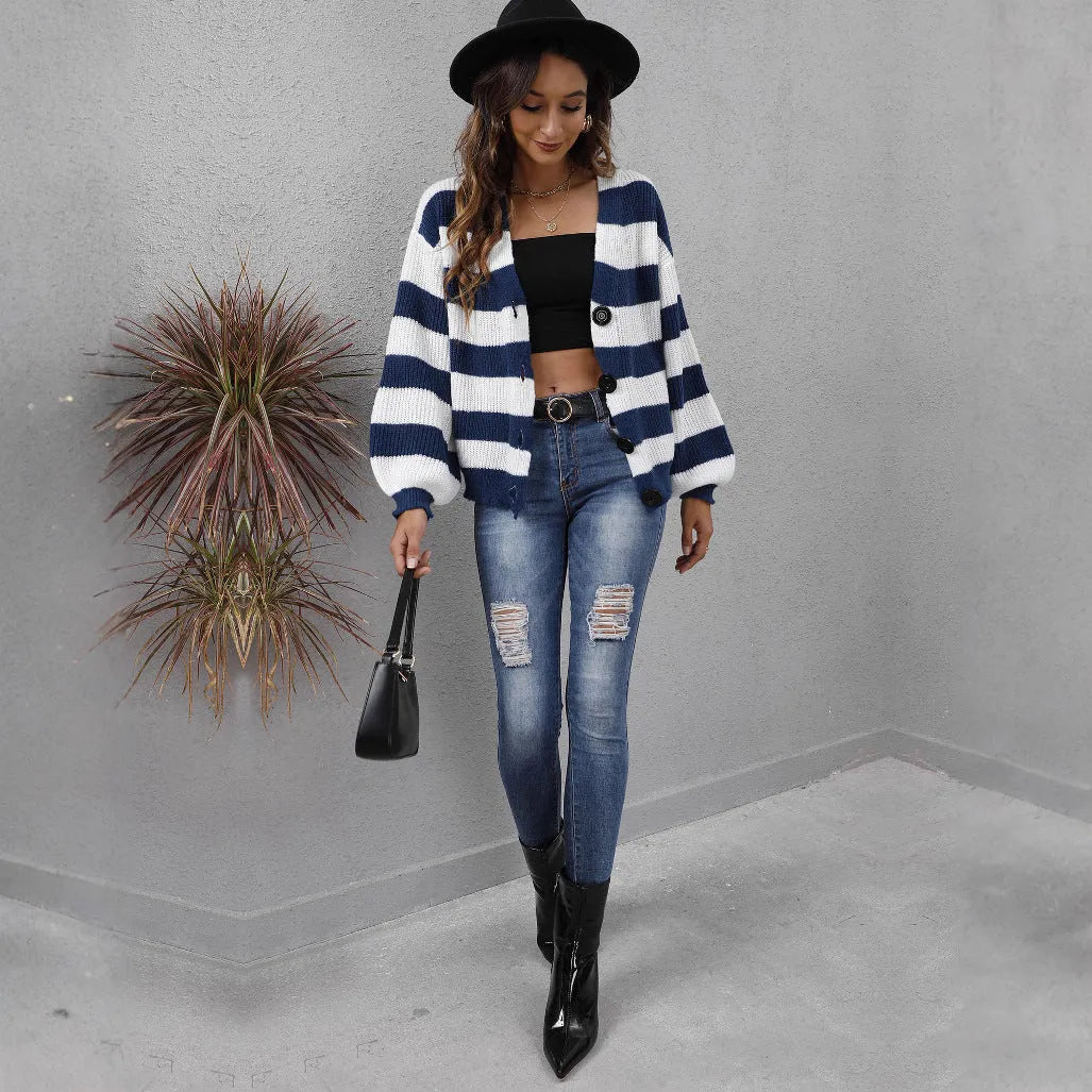 Blue striped women's cardigan sweater with buttons, shown on a hanger.