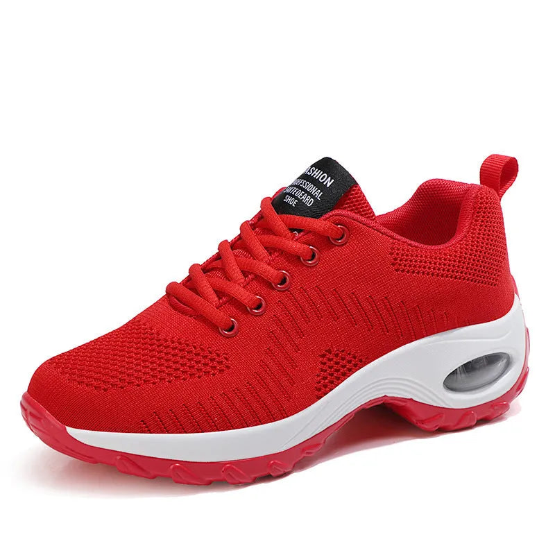 Red and black women's low-top mesh sneakers with front laces and a flat sole on a white background.