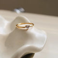 Golden stainless steel love heart ring with an oval ring bath design.