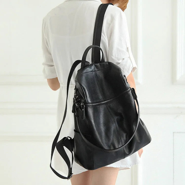 Brown genuine leather retro women's backpack with front pocket and adjustable straps.