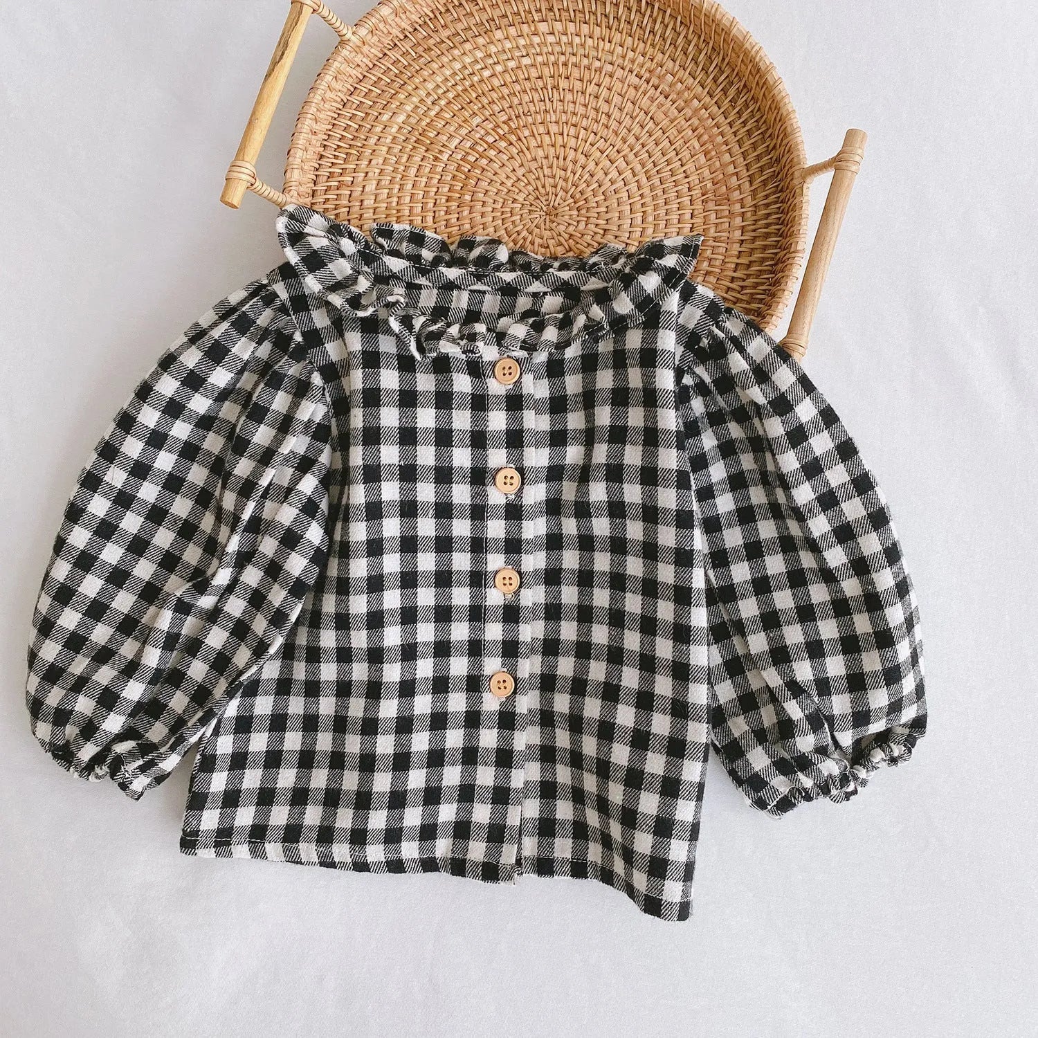 Baby girl wearing a cotton pleated skirt romper with lotus leaf sling design in apricot colour