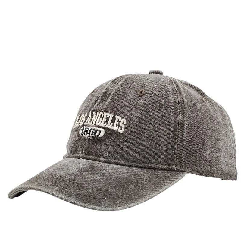 Retro beige personalised washed cotton peaked cap with adjustable strap and embroidered letters on the front.