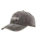 Retro beige personalised washed cotton peaked cap with adjustable strap and embroidered letters on the front.