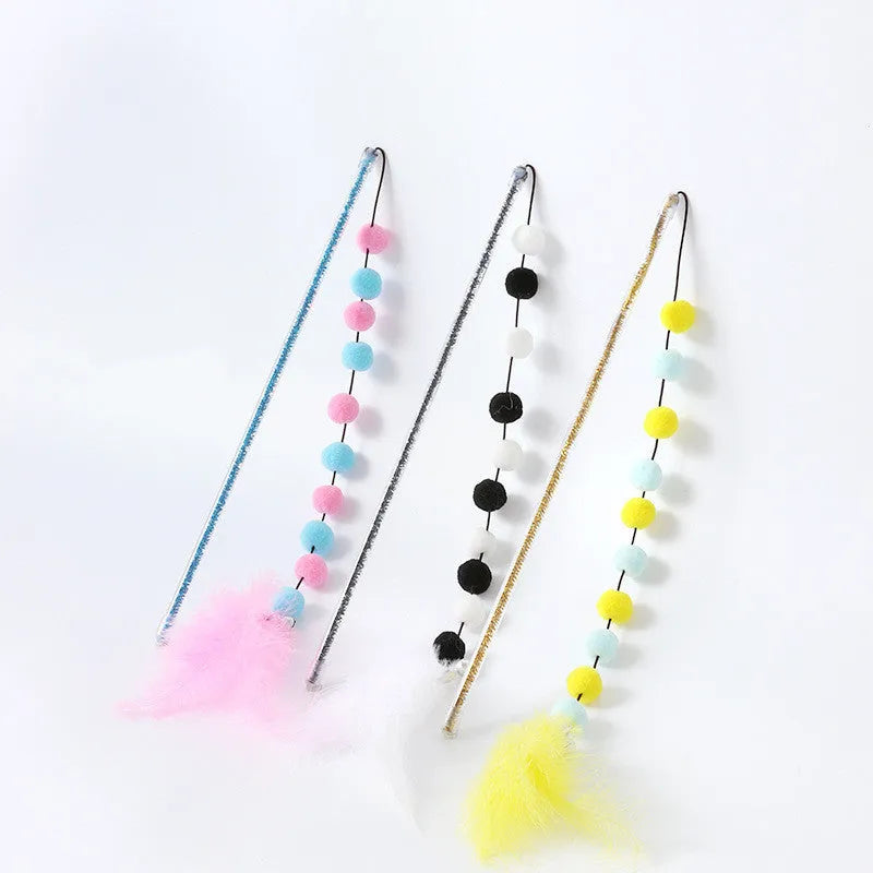 Cat toy teaser stick with plush ball and feathers, approximately 31 cm long, on a plain background.