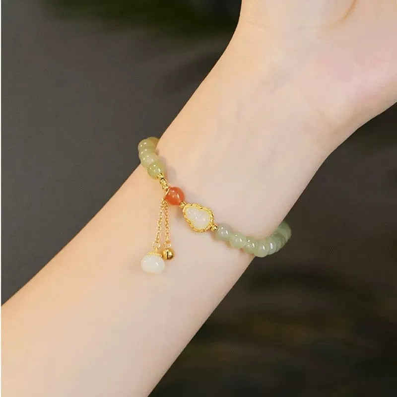 Qingshui jade bracelet with gold-plated details and a fu character on 6mm beads.