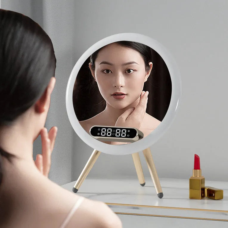 White multi-function LED mirror alarm clock with wireless charger and Bluetooth speaker on a table