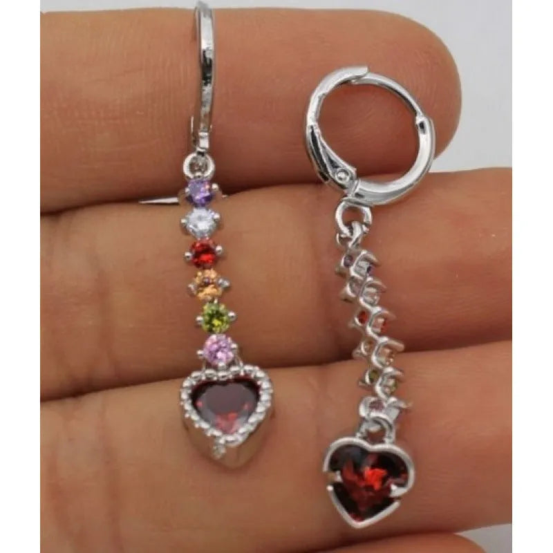 A pair of women's heart-shaped earrings with an electroplated gold or silver finish on an alloy base.