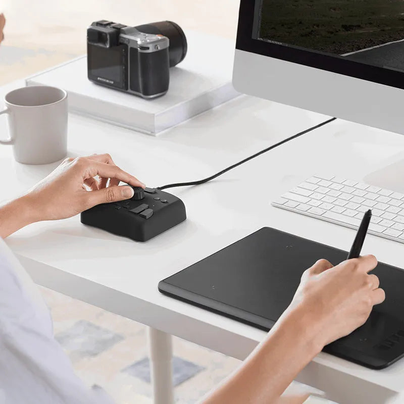 TourBox NEO video editing controller auxiliary keyboard with dials and buttons on a black PC+ABS housing.