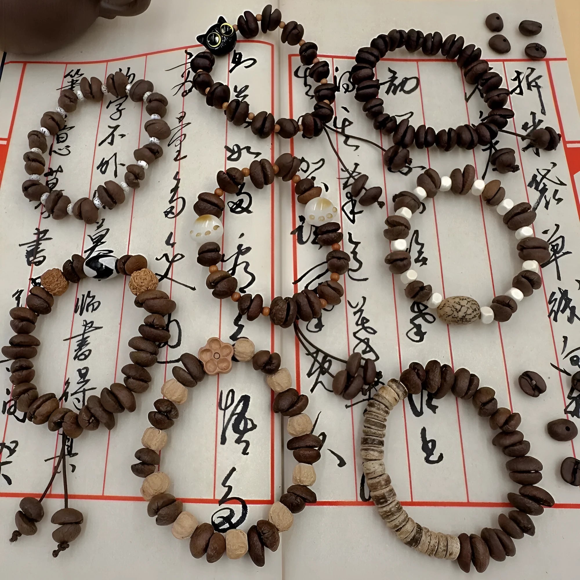 Handmade coffee bean bracelet with 16mm geometric charm showing colour variations
