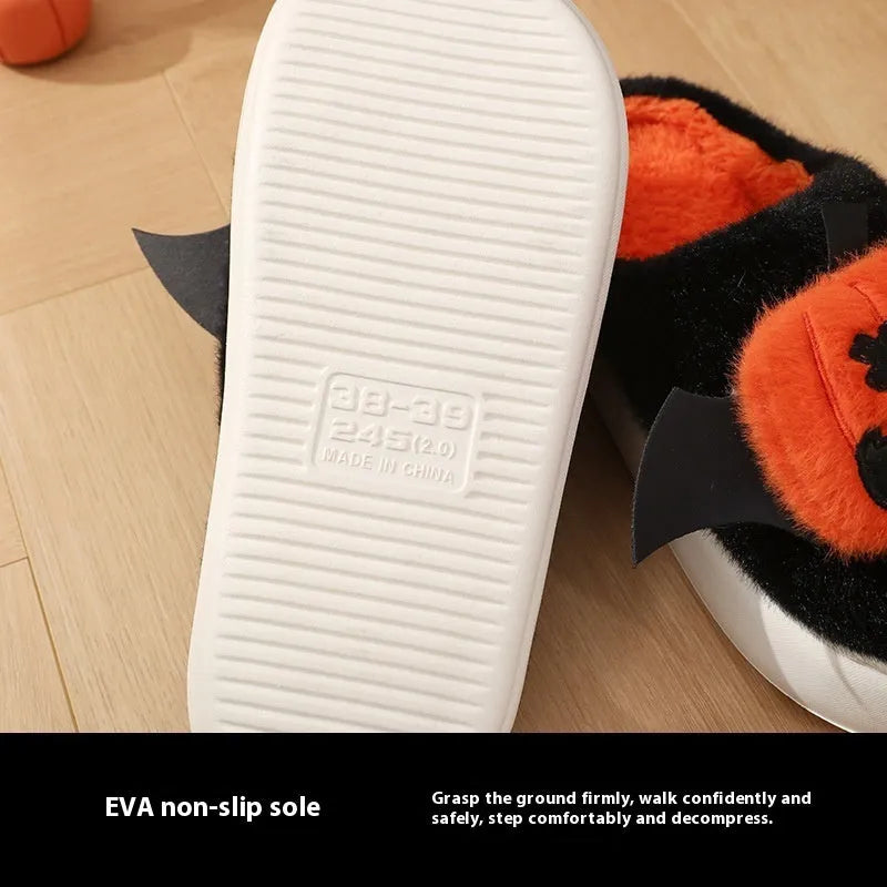 Black Halloween cartoon pumpkin slippers with small wings design on indoor floor