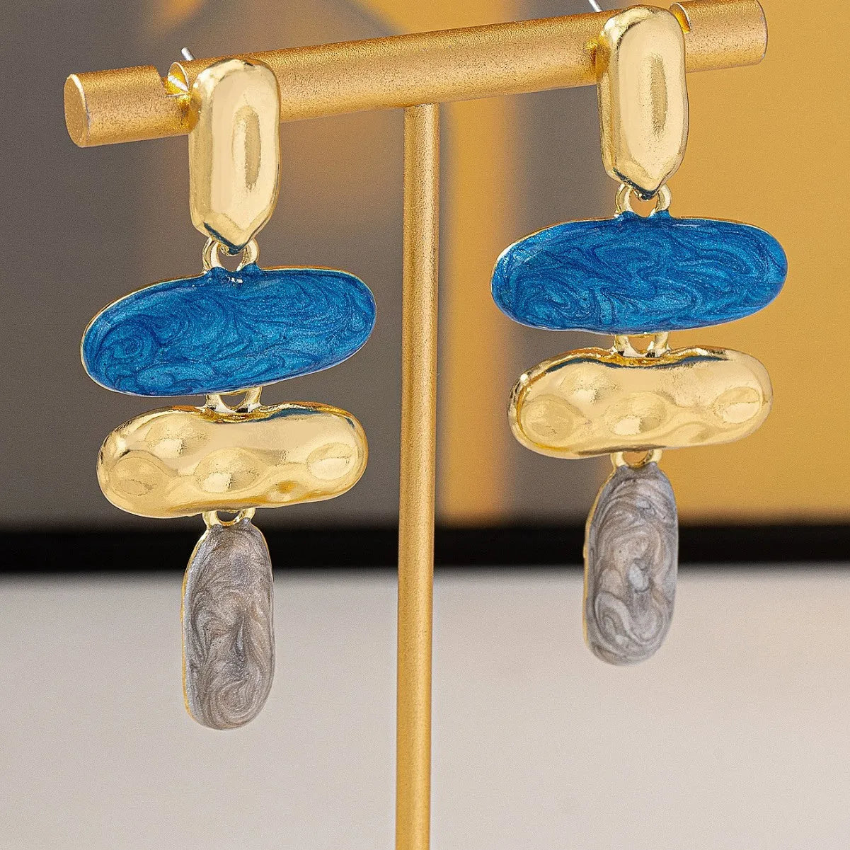 A pair of women's geometric stud earrings with a multicolour electroplated finish on zinc alloy.