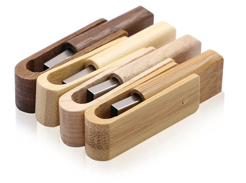 Pink wooden USB flash drive with rotating clip on a light background showing its natural wood grain and compact size