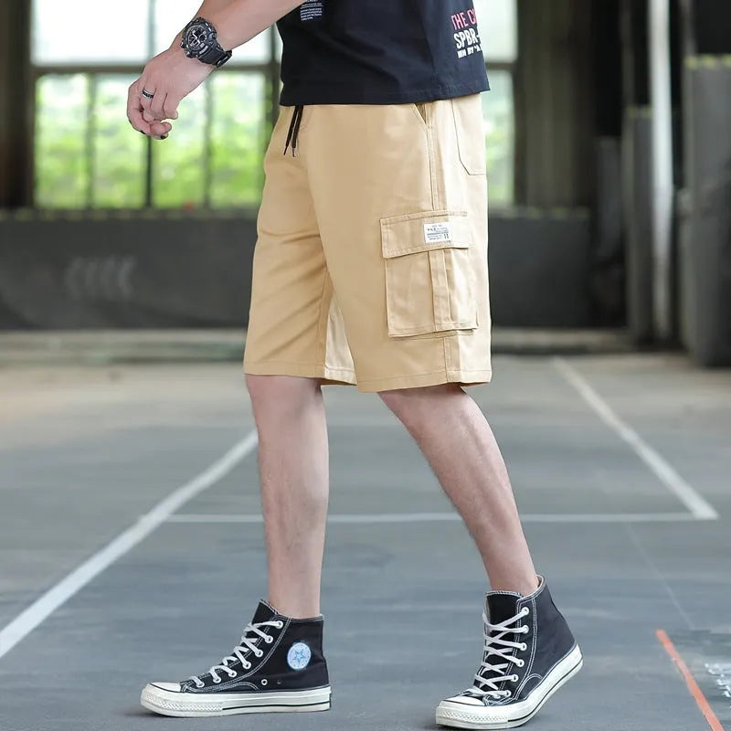 Man modelling loose fit khaki casual trousers with a giraffe pattern gradient detail.
