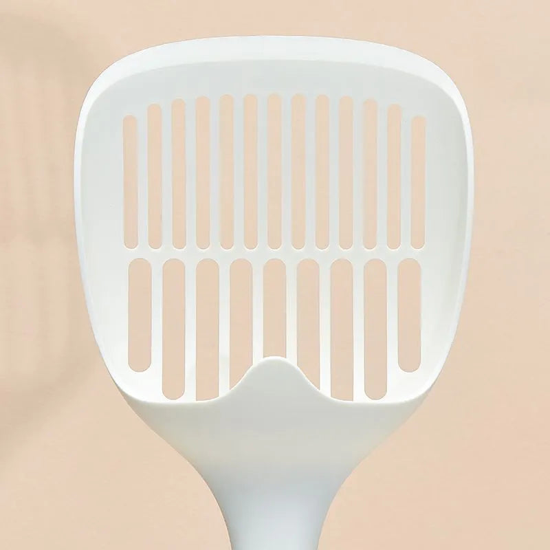 White plastic cat litter scoop with an attached storage base on a white background.
