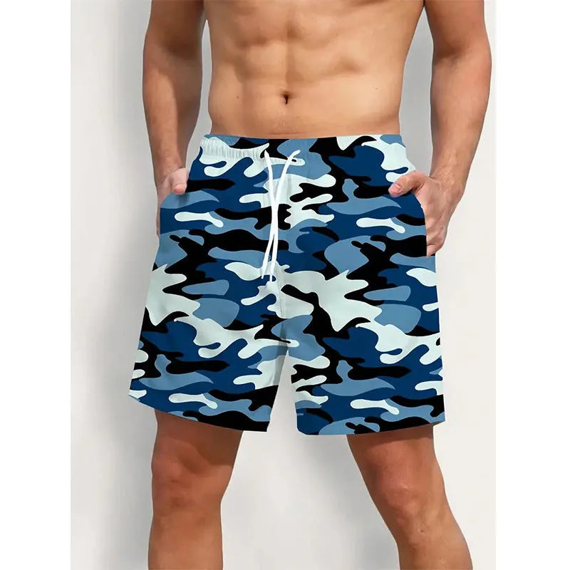 Man wearing coloured print polyester beach shorts with an elastic waistband for summer travel.