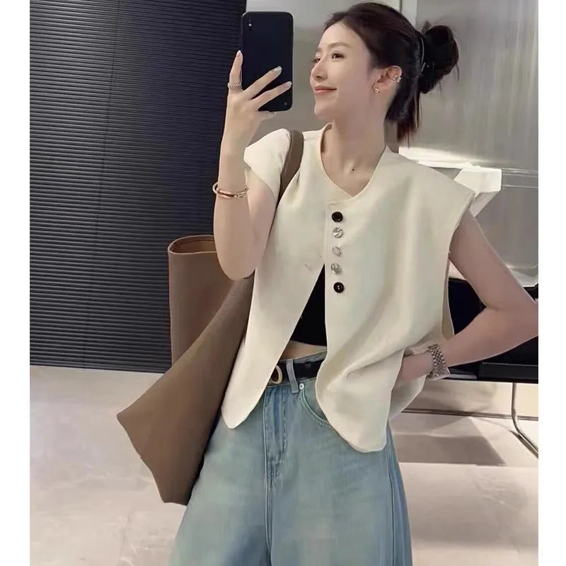 Women's loose fit polyester vest in milky white with pockets, shown on a hanger.