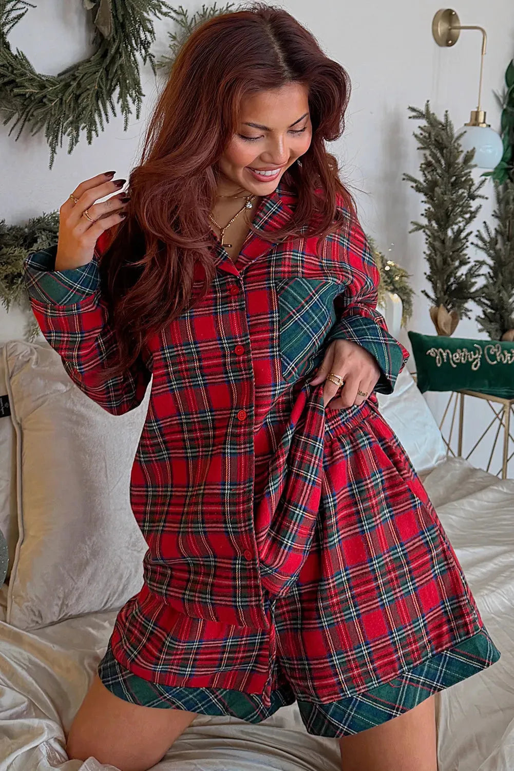 Red plaid Christmas pyjama set with contrast patch on shirt and matching shorts, laid flat.