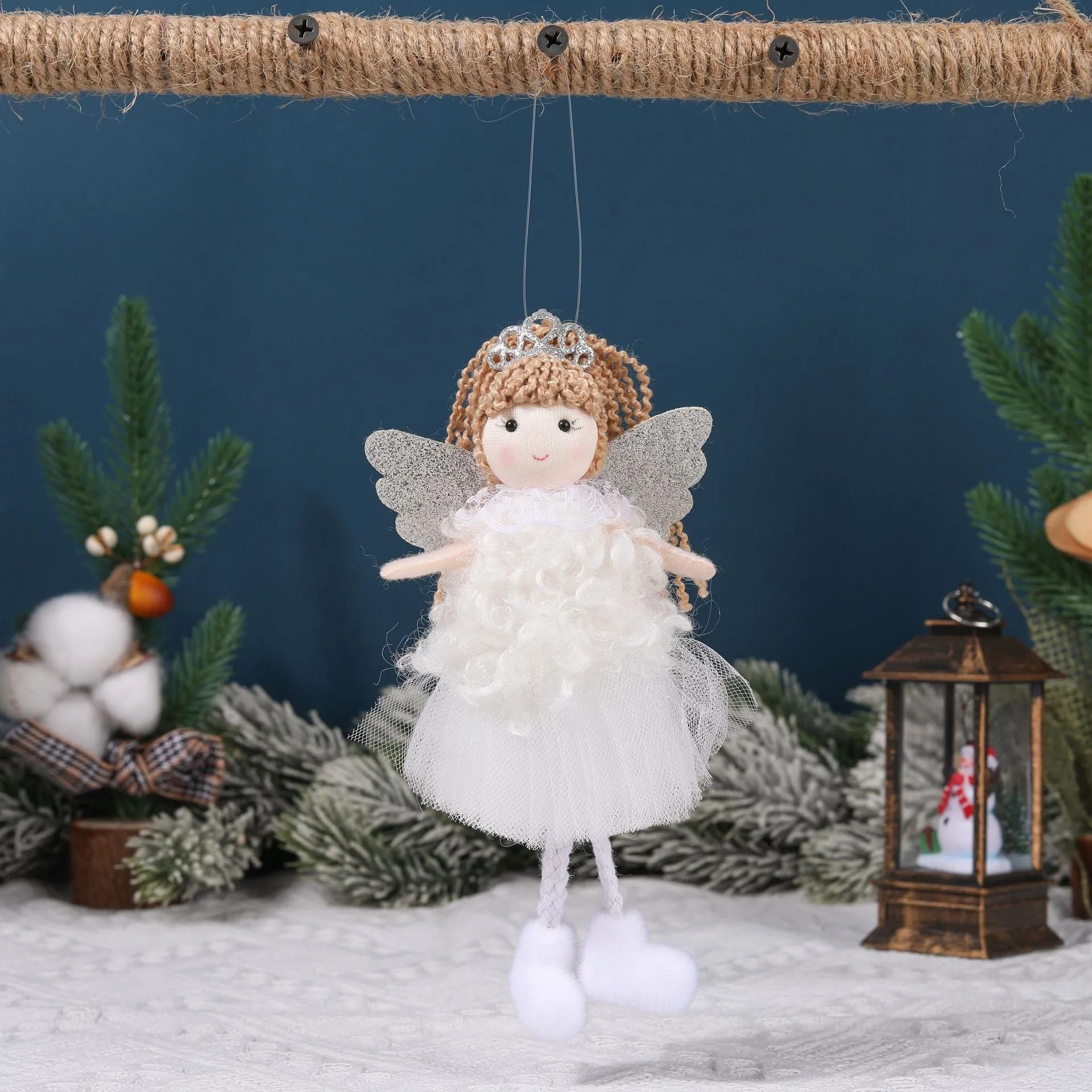 Cartoon angel cloth hair pendant on a girl's high ponytail in white, pink, and khaki colours.