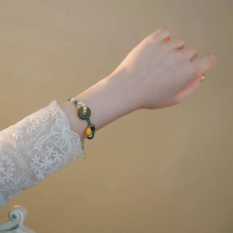 Hand-woven flexible wire watch bracelet with pearl peace buckle closure on wrist