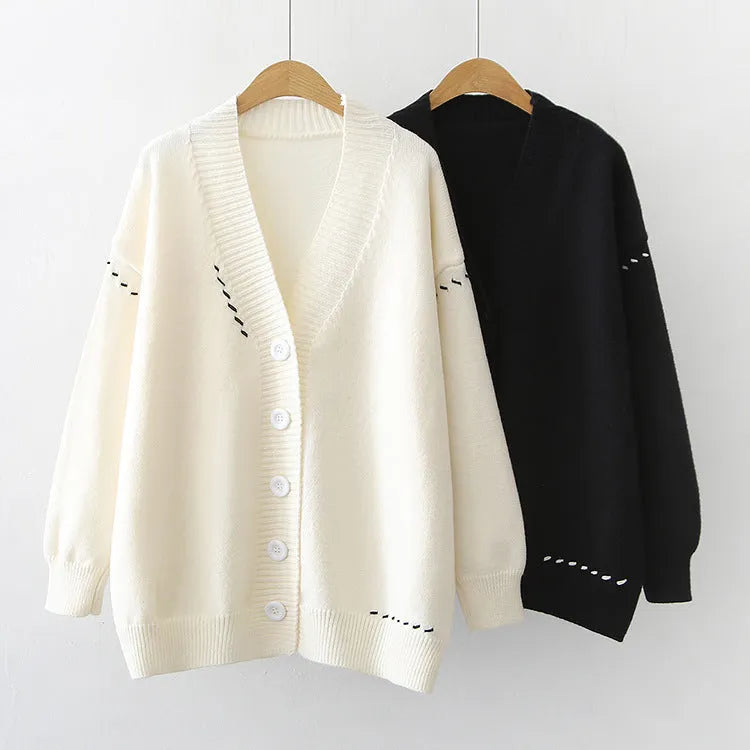 Women's loose black knitted cardigan coat with long sleeves.