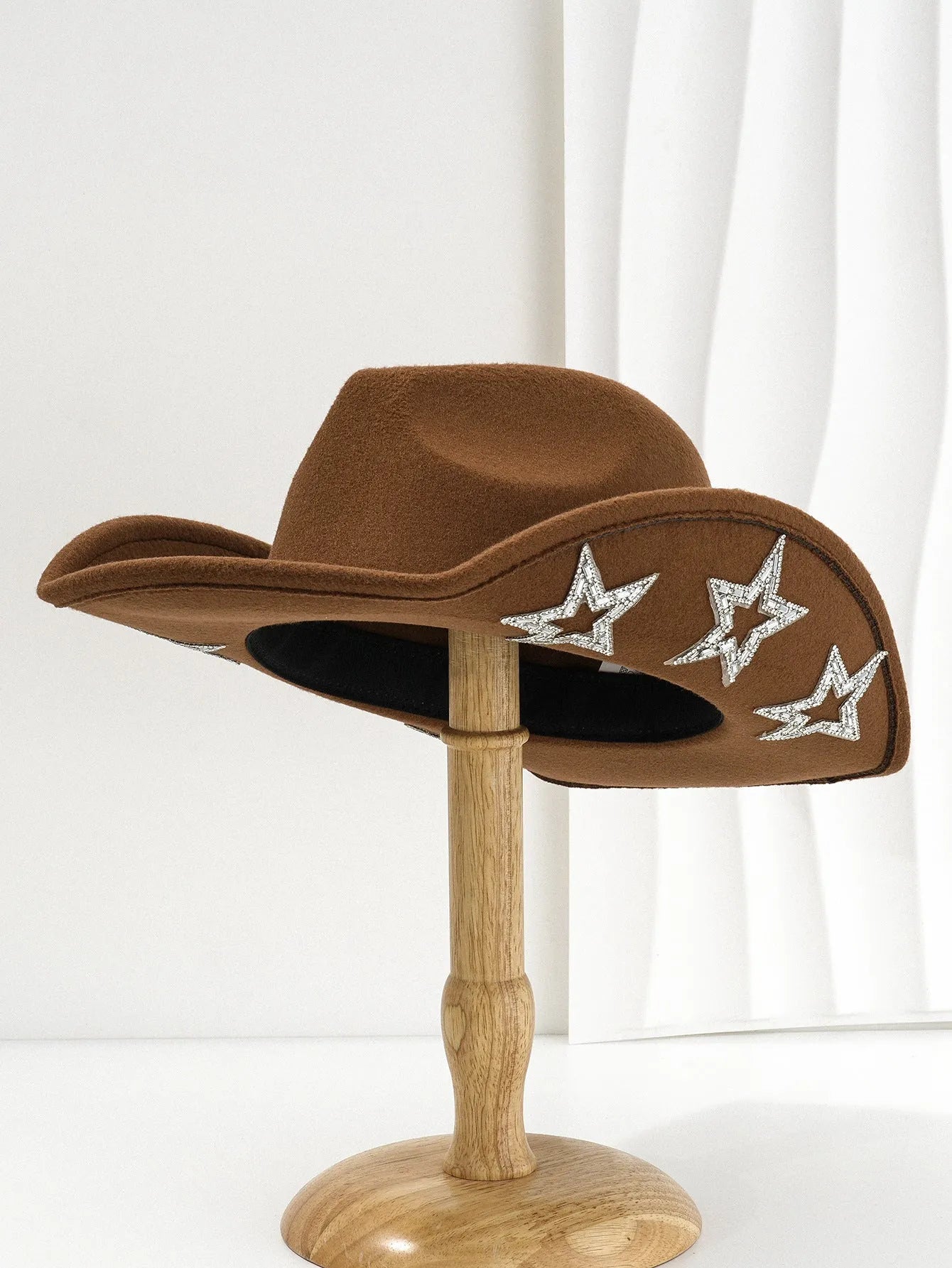 Beige wool felt western cowboy hat with a hexagonal star on the side, conical crown.