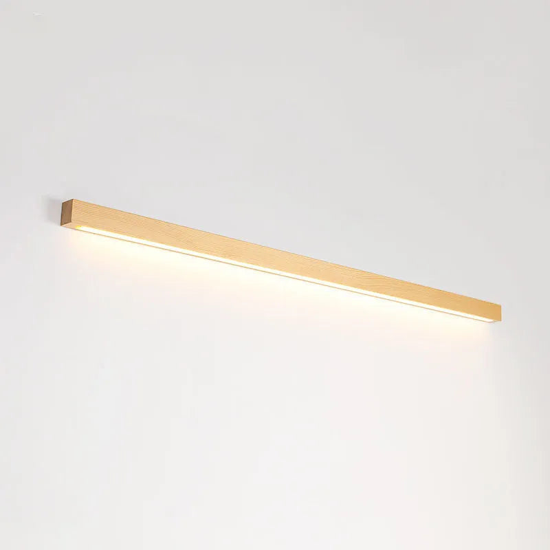 Walnut-coloured minimalist log strip wall lamp mounted on a wall.