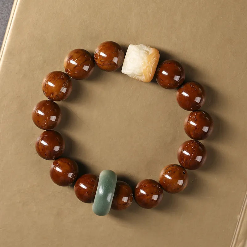 Hand-woven bracelet with 13mm round beads showing lion design in ivory nut, bodhi or sandalwood style