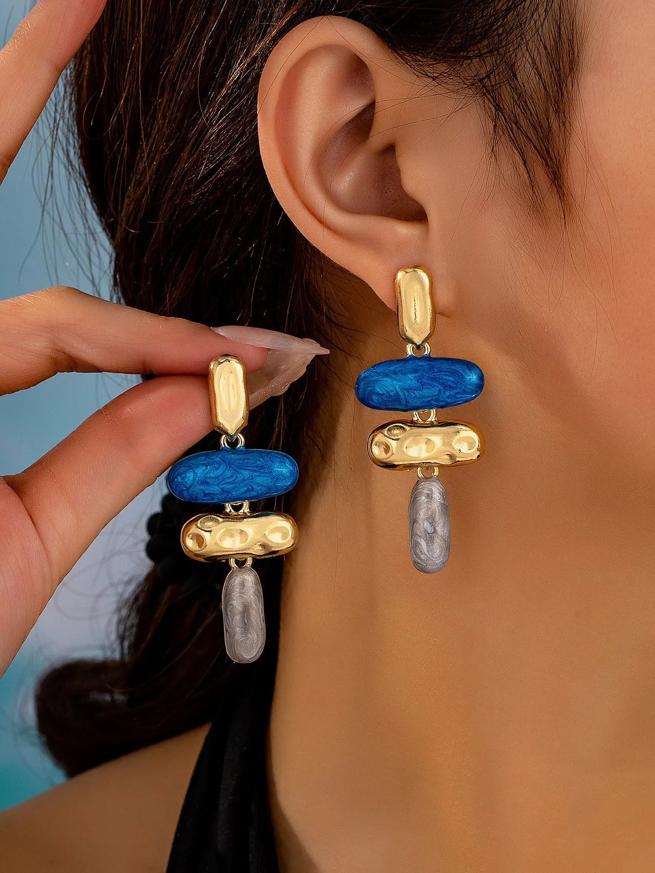 A pair of women's geometric stud earrings with a multicolour electroplated finish on zinc alloy.