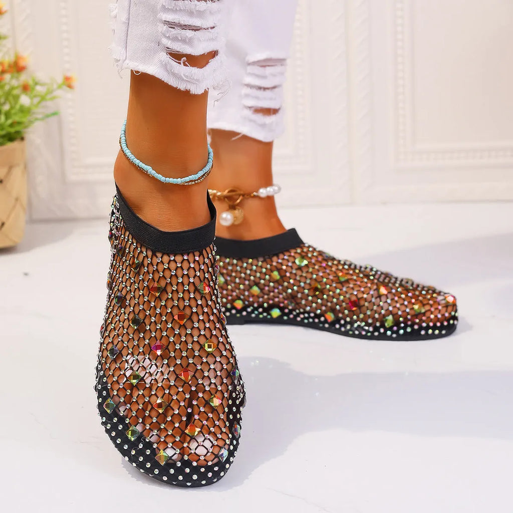 Women's flat sandals with a colourful rhinestone design on a breathable mesh upper and a rubber sole.