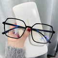 Women's fashion flat glasses with transparent plate frame and AC lenses on a white background