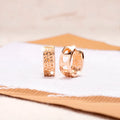 Rose gold women's earrings with three hollowed-out hearts in a circular, sweet style.