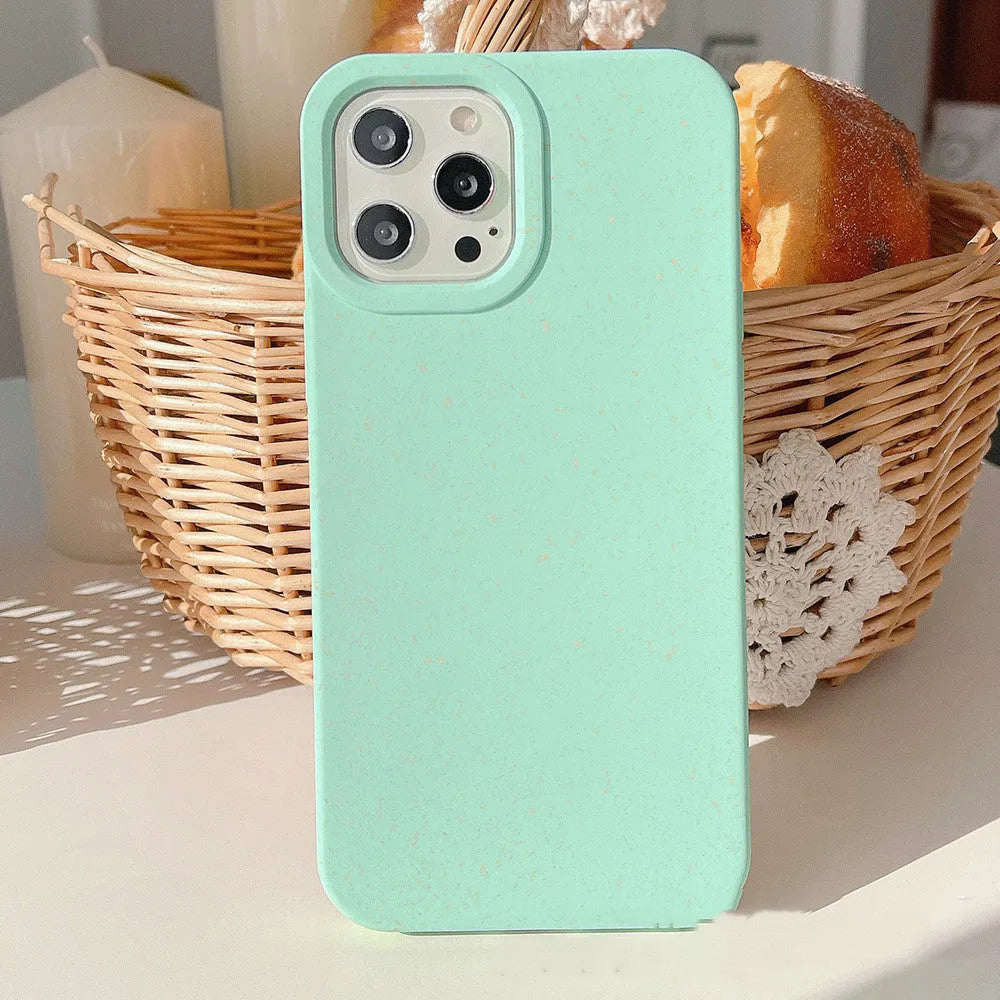 Biodegradable wheat straw mobile phone case for iPhone in seven colour options on a table.