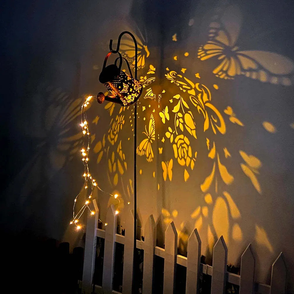 Solar garden lamp with tapered butterfly pattern in iron construction emitting warm white light