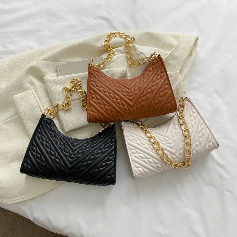Black PU leather pleated square baguette bag with chain shoulder strap and top handle.