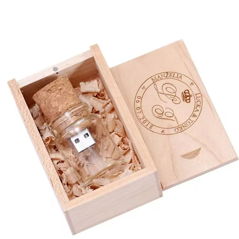 Wooden and transparent glass bottle-shaped USB flash drive on a wooden surface.