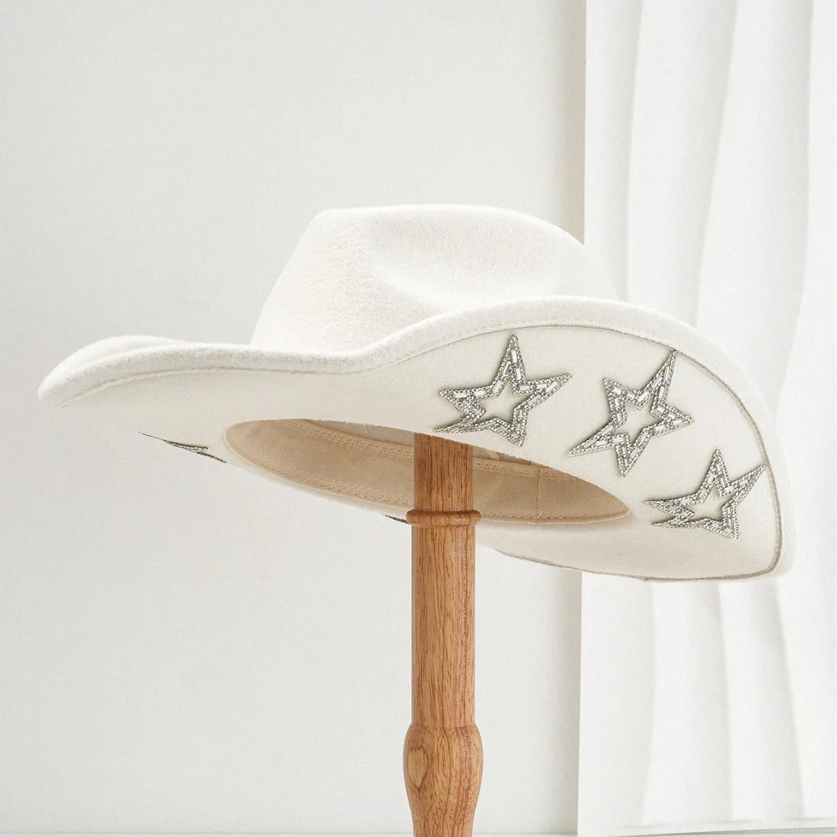 Beige wool felt western cowboy hat with a hexagonal star on the side, conical crown.
