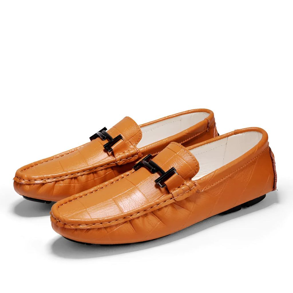 Men's black casual leather shoes with a silver belt buckle detail on the front.