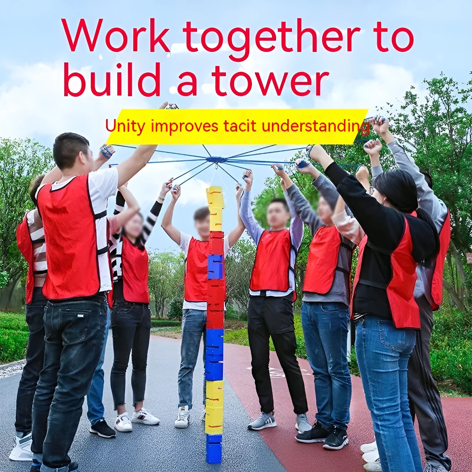Outdoor team building game set showing coloured ABS plastic tower blocks, pull ropes, and a central hook frame on grass.