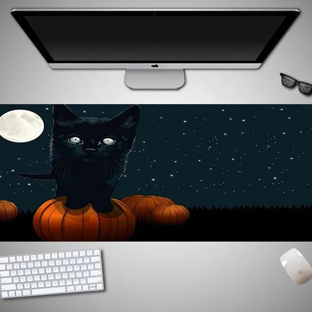 Large Halloween-themed rubber cloth mouse pad on a desk, showing non-slip backing and graphic design.
