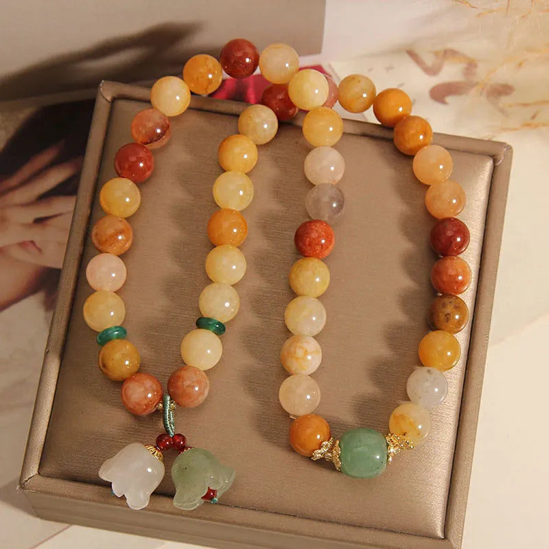 Natural Jinsi Jade multi-layer women's bracelet with adjustable cord tie closure and orchid pendant