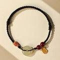Hetian jade peace buckle bracelet with 10mm stone on a braided rope
