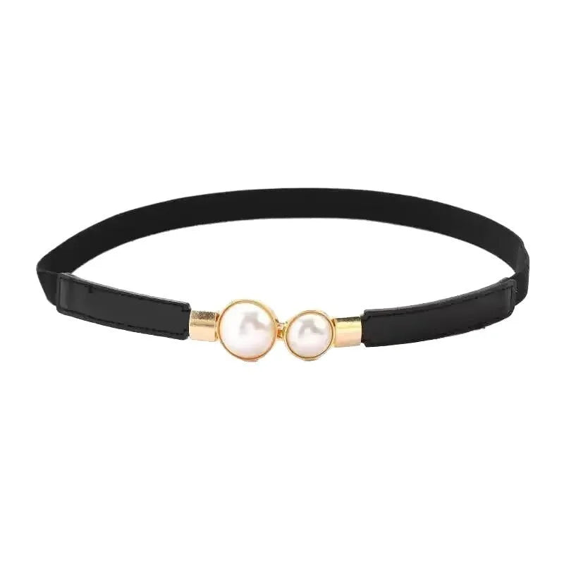 Thin black PU leather women's decorative belt with an alloy buckle on a pair of jeans.