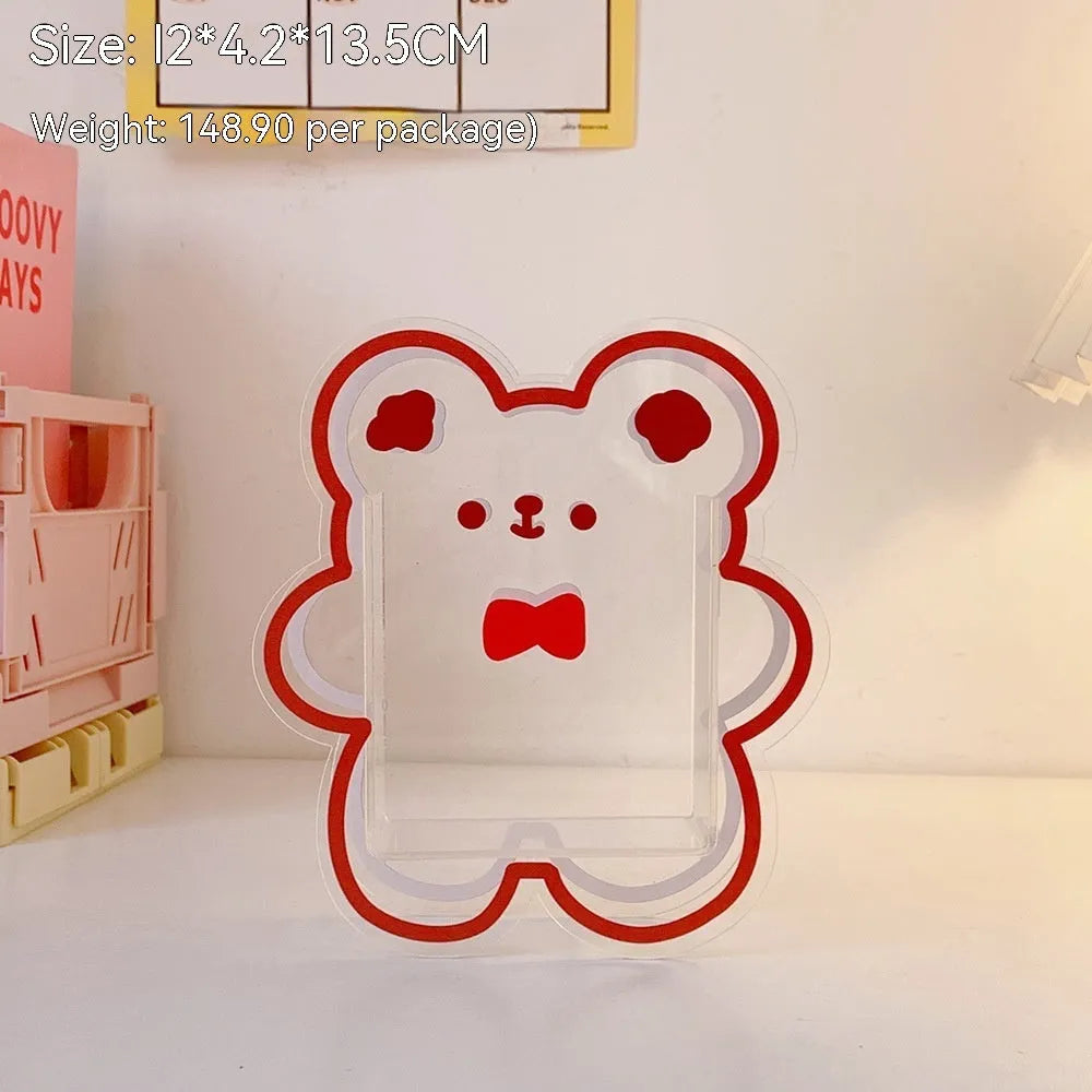 Square transparent acrylic storage box with a cute decorative design, shown on a desk.