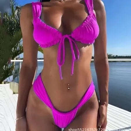 Women's solid colour lace-up bikini swimsuit with split briefs on a mannequin.